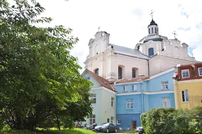 a large building with a tower on top of it at 2 bedroom old town apartment with parking in Vilnius