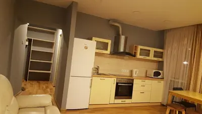 a kitchen with a white refrigerator and a table at 2 bedroom old town apartment with parking in Vilnius