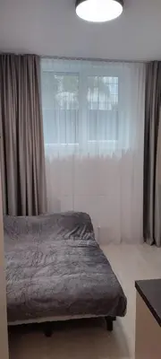 a bed sitting in a bedroom with a window at QuickStopVilnius in Vilnius