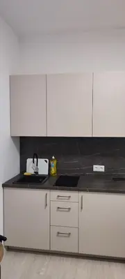 a kitchen with white cabinets and a black counter top at QuickStopVilnius in Vilnius