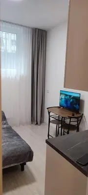 a living room with a table with a laptop on it at QuickStopVilnius in Vilnius