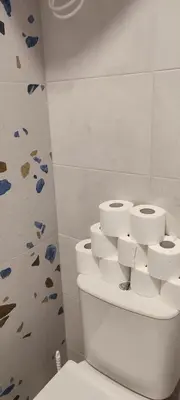 a bathroom with a toilet with rolls of toilet paper at QuickStopVilnius in Vilnius