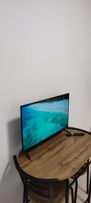 a computer monitor sitting on top of a wooden table at QuickStopVilnius in Vilnius