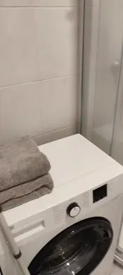 a washing machine with a towel on top of it at QuickStopVilnius in Vilnius