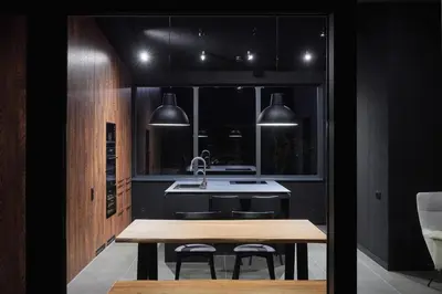 a kitchen with a wooden table and a sink at The Barn