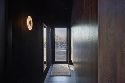 an empty hallway with a door and a window at The Barn