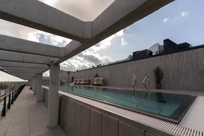 a swimming pool on the roof of a building at Sky Pool Escape Luxury Apartment in Druskininkai Center in Druskininkai