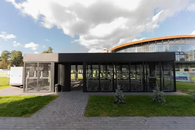 a large building with glass doors in front of it at Sky Pool Escape Luxury Apartment in Druskininkai Center in Druskininkai