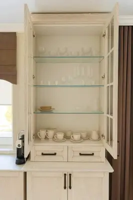 a hutch with cups and bowls on it in a kitchen at Draugystės Apartments - Šiauliai Center in Šiauliai