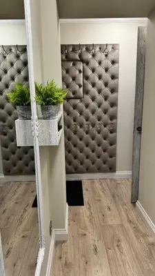 a room with a doorway with a mirror and plants at Draugystės Apartments - Šiauliai Center in Šiauliai