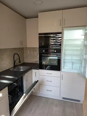 a kitchen with white cabinets and a sink at Vieno kambario butas Šiauliuose in Šiauliai