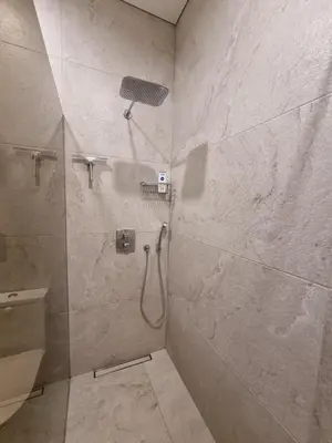 a bathroom with a shower with a shower head at Vandens takas in Birštonas