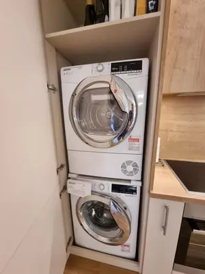 a washer and dryer in a small kitchen at Vandens takas in Birštonas