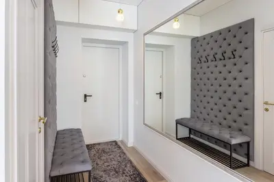 a dressing room with a mirror and a bench at Central Stay Apartments in Šiauliai