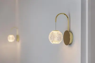 a bathroom with two lights on the wall at Central Stay Apartments in Šiauliai