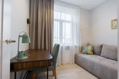 a living room with a table and a couch at Central Stay Apartments in Šiauliai