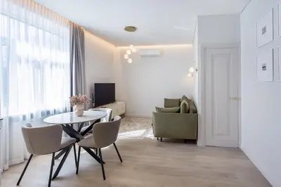 a living room with a table and chairs at Central Stay Apartments in Šiauliai