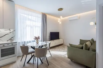 a living room with a table and a couch at Central Stay Apartments in Šiauliai