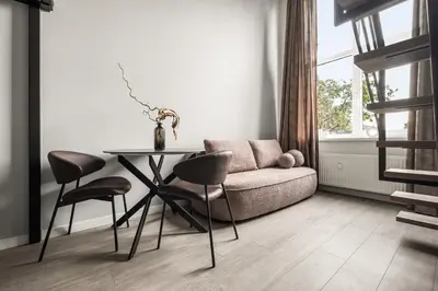 a living room with a table and a couch at Golden loft in City centre Self check-in No 38 in Vilnius