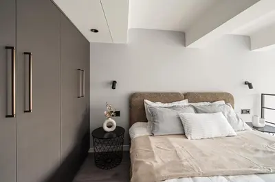 a bedroom with white walls and a bed with white pillows at Golden loft in City centre Self check-in No 38 in Vilnius