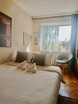 a large white bed with two stuffed animals on it at Cozy Apartment in Kaunas with Free Parking. in Kaunas