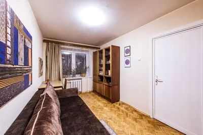 a living room with a couch and a window at Cozy Apartment in Kaunas with Free Parking. in Kaunas