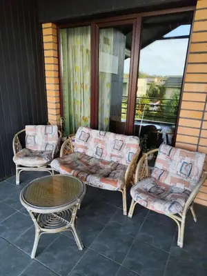 three chairs and a table on a porch at Studija viloje-Quiet Apartment 15 min from Airport in Kaunas