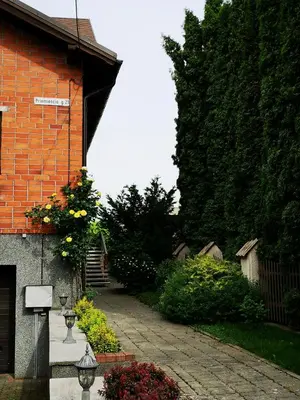 a brick building with a street sign on it at Studija viloje-Quiet Apartment 15 min from Airport in Kaunas