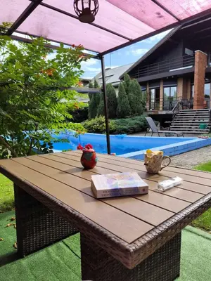 a wooden table with a book on top of it at Studija viloje-Quiet Apartment 15 min from Airport in Kaunas