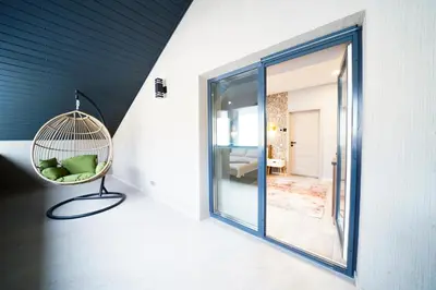 a room with a bird cage on the wall at Svaja ApartHotel & SPA in Šiauliai