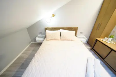 a bedroom with a large bed with white sheets at Svaja ApartHotel & SPA in Šiauliai