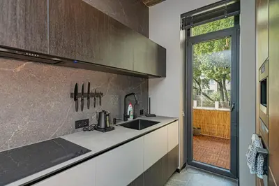 a kitchen with a sink and a counter top at Design 2 BD Apartment with Hot Tube by Domvia in Kaunas