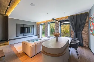 a living room with a couch and a table at Design 2 BD Apartment with Hot Tube by Domvia in Kaunas