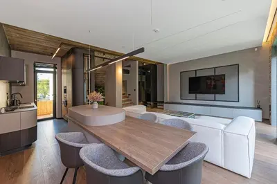 a living room with a table and some chairs at Design 2 BD Apartment with Hot Tube by Domvia in Kaunas