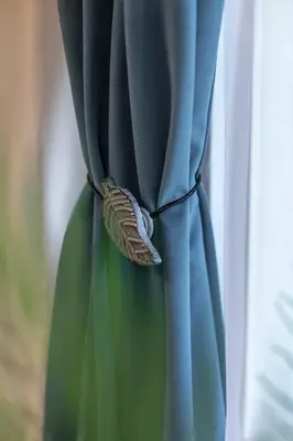 a blue curtain with a knot in a window at Old Town Retreat in Vilnius in Vilnius