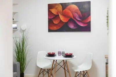 a table and chairs in a room with a painting at Old Town Retreat in Vilnius in Vilnius