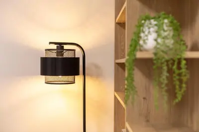 a lamp sitting next to a wall with a shelf at Old Town Retreat in Vilnius in Vilnius