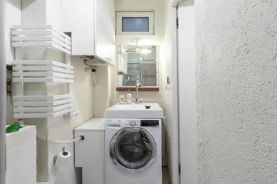 a laundry room with a washing machine and a sink at Old Town Retreat in Vilnius in Vilnius
