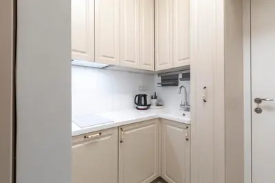 a kitchen with white cabinets and a sink at Old Town Retreat in Vilnius in Vilnius