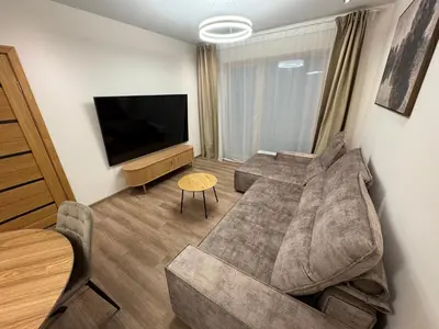 a living room with a couch and a flat screen tv at Lovely Flat with Great Central Location Kaunas in Kaunas