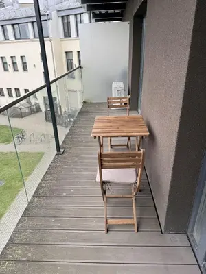 two chairs and a table on a balcony at Lovely Flat with Great Central Location Kaunas in Kaunas