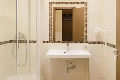 a bathroom with a sink and a shower at Vilnius City Room in Vilnius