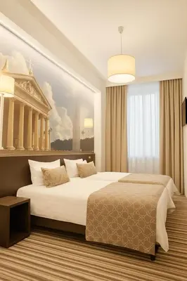 a bedroom with a large bed and a painting on the wall at Vilnius City Room in Vilnius