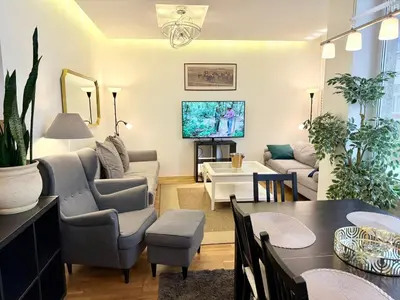 a living room with a couch and a table at Pilies23 Old Town Luxury Apartment in Vilnius