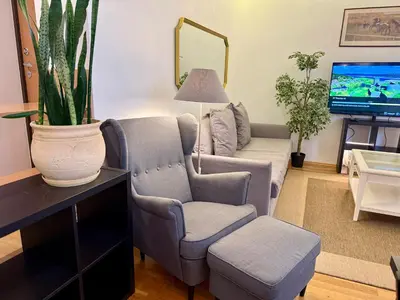 a living room with a couch and a chair at Pilies23 Old Town Luxury Apartment in Vilnius