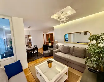 a living room with a couch and a table at Pilies23 Old Town Luxury Apartment in Vilnius