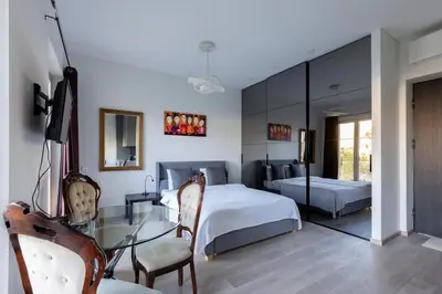 a bedroom with a bed and a glass table at Vilnius City Center Deluxe Apartment in Vilnius