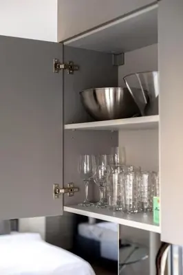 a shelf with wine glasses and a bowl on it at Vilnius City Center Deluxe Apartment in Vilnius