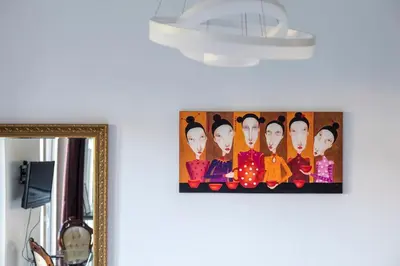 a picture of a group of people on a wall at Vilnius City Center Deluxe Apartment in Vilnius