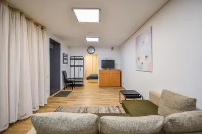 a living room with a couch and a tv at A cozy apartment with private entrance in the city centre in Panevėžys